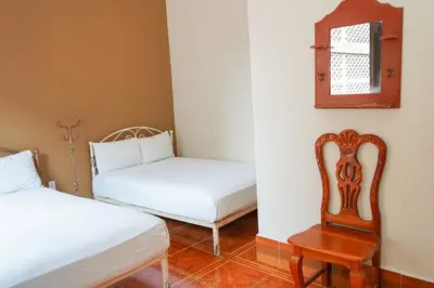 Cama o camas de una habitación en OYO Hotel El Conquistador