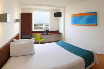 Cama o camas de una habitación en One Xalapa Las Animas