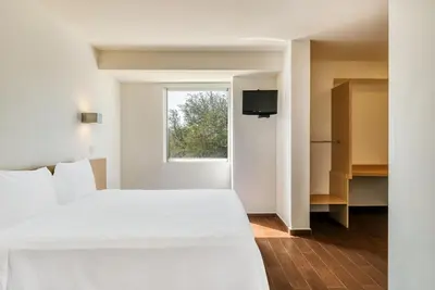 Cama o camas de una habitación en One Salina Cruz