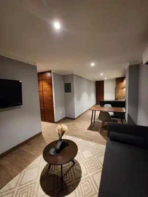 Una televisión o centro de entretenimiento en Modernos departamentos tipo LOFT a dos calles del estadio