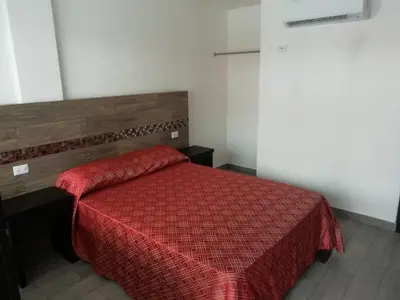 Cama o camas de una habitación en HOTEL QUINTERO
