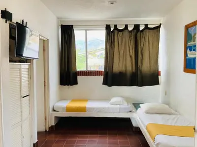 Cama o camas de una habitación en Suites Acapulco Yamba