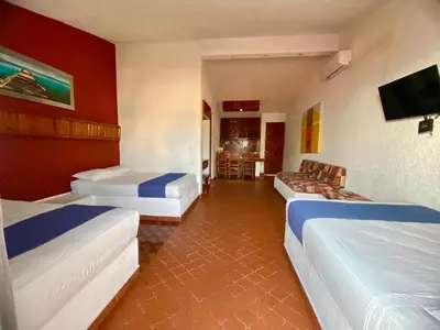 Cama o camas de una habitación en Suites Acapulco Yamba