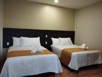 Cama o camas de una habitación en Hotel & Cabañas Malinche