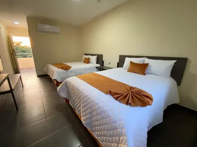 Cama o camas de una habitación en LOS BAMBUES HOTEL