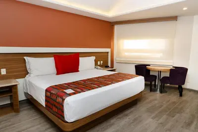 Cama o camas de una habitación en JF Grand Puebla