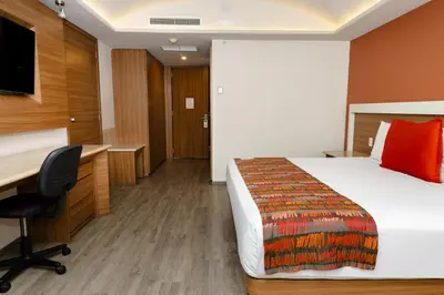 Cama o camas de una habitación en JF Grand Puebla
