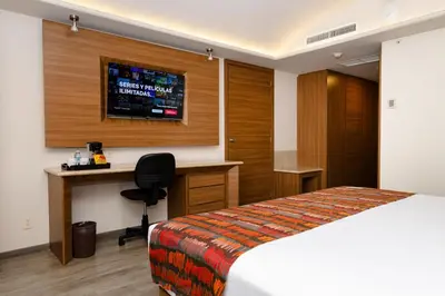 Cama o camas de una habitación en JF Grand Puebla