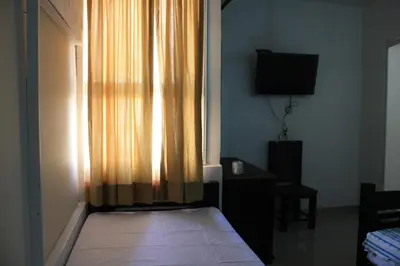 Una televisión o centro de entretenimiento en Hotel Calle8