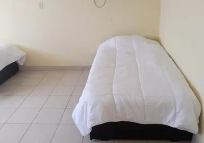 Cama o camas de una habitación en Hostal Las Quince Letras