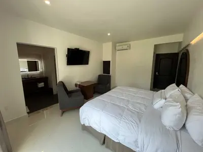 Cama o camas de una habitación en El Laurel Hotel Boutique