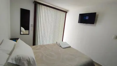 Cama o camas de una habitación en Depa Balcones cerca Estadio GNP, Palacio de los Deportes, Autódromo HR y Aeropuerto CDMX