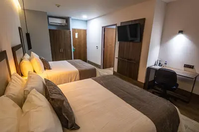 Cama o camas de una habitación en Hoteles Piedra Alta by De Los Perez