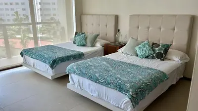 Cama o camas de una habitación en Isla Residences, frente al mar.