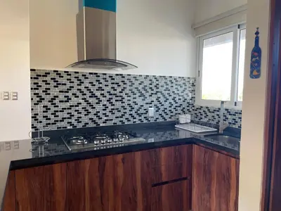 Una cocina o zona de cocina en Departamento de Lujo & Club de Playa