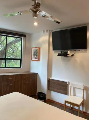Una televisión o centro de entretenimiento en Suites del Valle