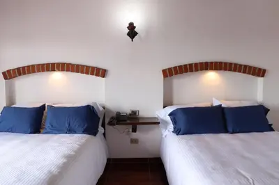 Cama o camas de una habitación en Hotel Cuamanco