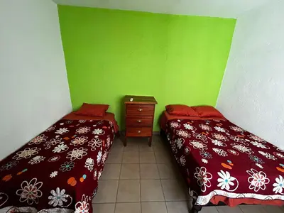 Cama o camas de una habitación en Casa Flor de Mayo