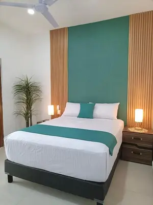 Cama o camas de una habitación en Hotel Punta Colibrí