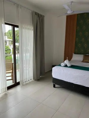 Cama o camas de una habitación en Hotel Punta Colibrí