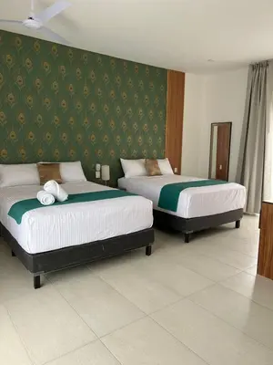 Cama o camas de una habitación en Hotel Punta Colibrí