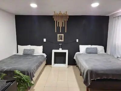 Cama o camas de una habitación en Hermoso Loft a 15min AICM