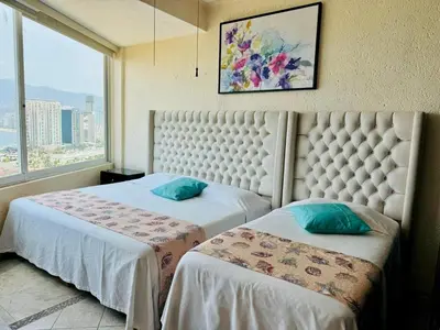 Cama o camas de una habitación en 3 Atardeceres, Pet Friendly Vista al Mar en Brisas