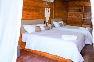 Cama o camas de una habitación en Riverside Hotel Chachalacas