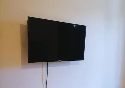 Una televisión o centro de entretenimiento en Depa a 3 min de Plaza Portales