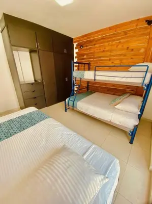 Cama o camas de una habitación en Frente playa equipado con alberca