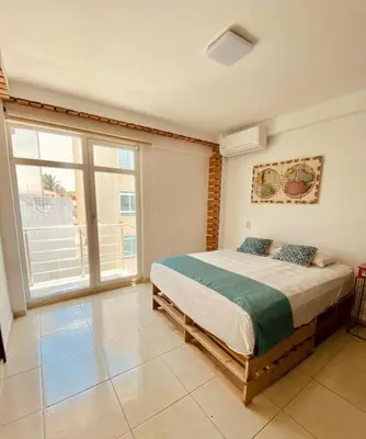 Cama o camas de una habitación en Frente playa equipado con alberca