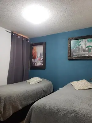 Cama o camas de una habitación en Departamento Jardín Magnolia