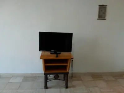 Una televisión o centro de entretenimiento en Mayan Vidanta PLAYA departamento 4 albercas