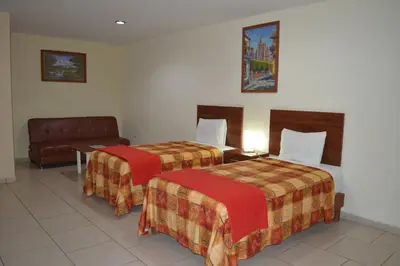 Cama o camas de una habitación en Hotel Ciprés Puebla