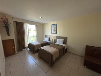 Cama o camas de una habitación en Hotel Ciprés Puebla