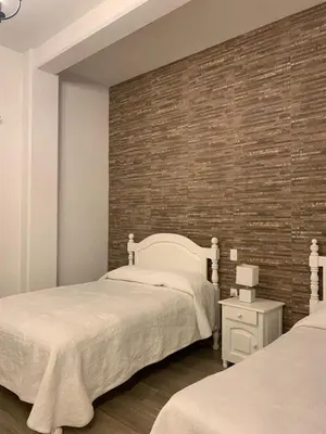 Cama o camas de una habitación en Hotel El Encuentro