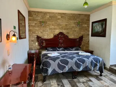 Cama o camas de una habitación en Hotel Las Flores