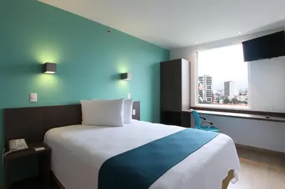 Cama o camas de una habitación en One Periferico Sur