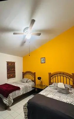 Cama o camas de una habitación en Casa Orquídeas Oaxaca