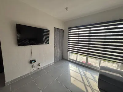 Una televisión o centro de entretenimiento en Departamento Acapulco Barra Vieja & Club de Playa