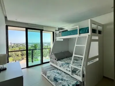 Cama o camas de una habitación en Depto en la playa con toboganes, juegos y restaurantes
