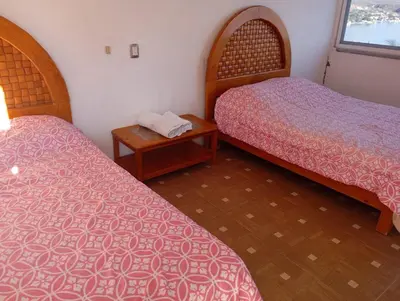 Cama o camas de una habitación en Casa rústica en zona dorada Cerca zona hoteles restaurantes y tiendas Casa privada con Muchas habitaciones