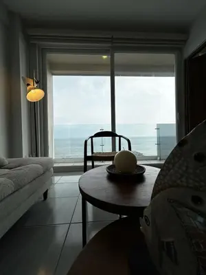 Zona de estar de Frente a la Playa con acceso directo AC Alberca y Elevador