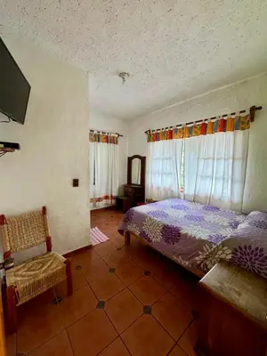 Cama o camas de una habitación en Hospedaje Teponaztle