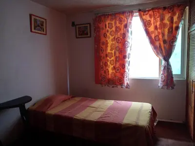 Cama o camas de una habitación en Casa familiar cerca del Centro