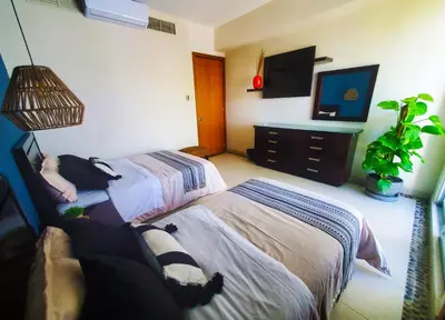Cama o camas de una habitación en Departamento Mayan Lakes T9 - Albercas, club de playa, tenis, pádel y más