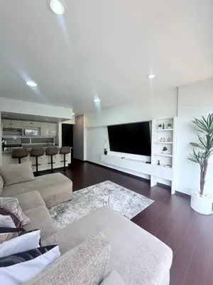 Una televisión o centro de entretenimiento en Departamento con Alberca
