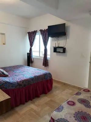 Cama o camas de una habitación en FRENTE AL MAR, centrico