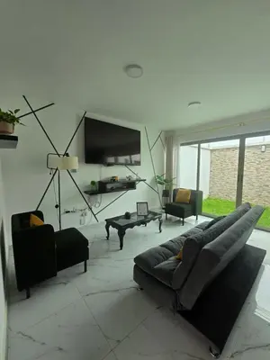 Una televisión o centro de entretenimiento en Casa Moderna El Vergel
