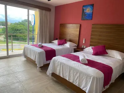Cama o camas de una habitación en Aeropuerto Express Huatulco